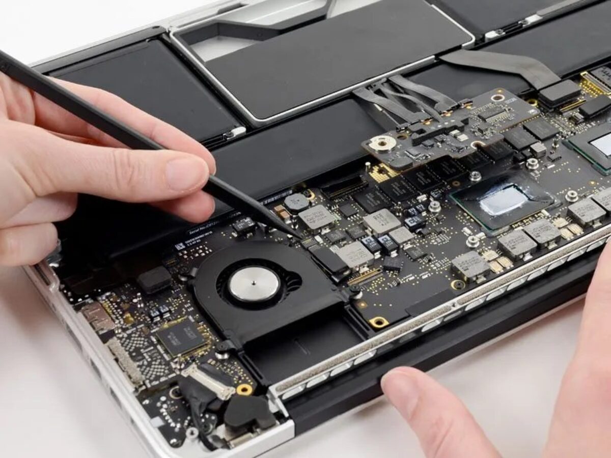 iMac and MacBook logic board being inspected