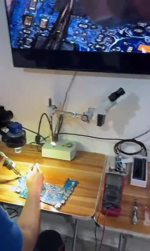 Board-level repair being carried out under microscope in the GadgyFix workshop